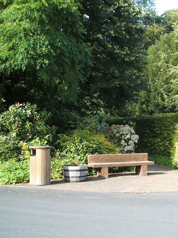 a seating area next to some bushes